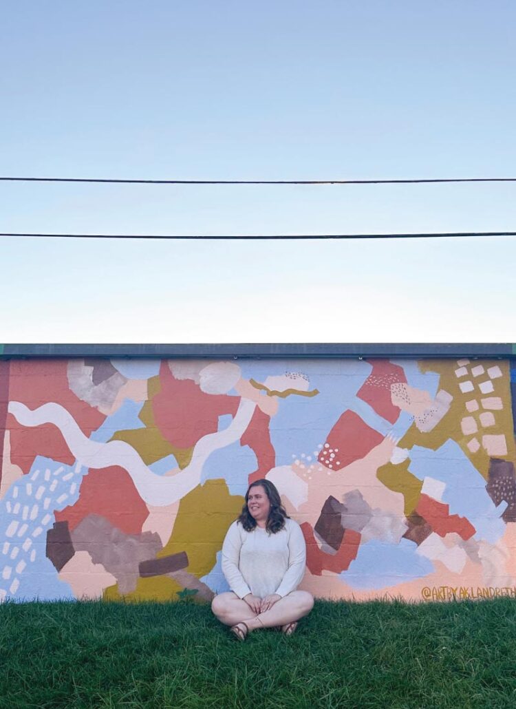 Hannah in front of a mural at Artivity on the Green in Winston-Salem, NC
