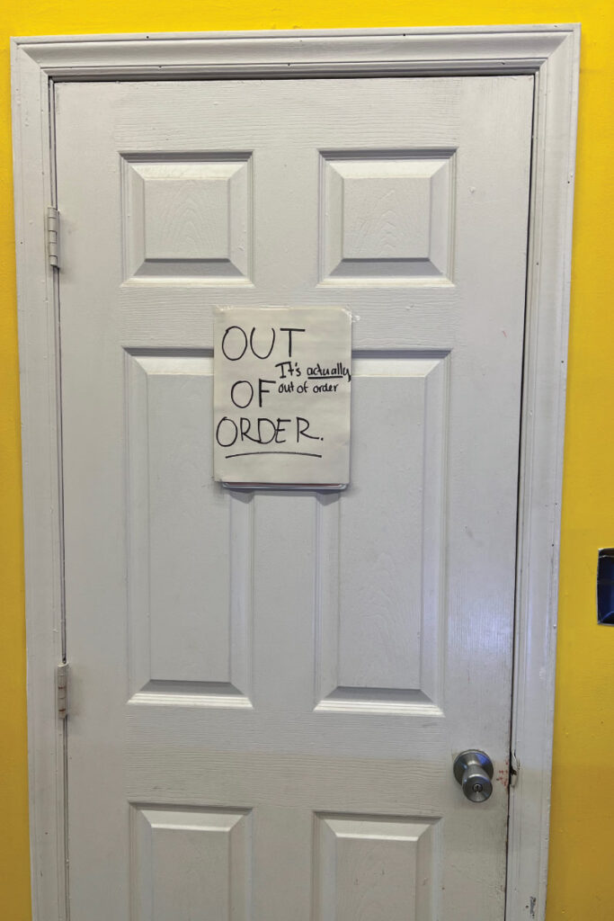 out of order sign on a bathroom door